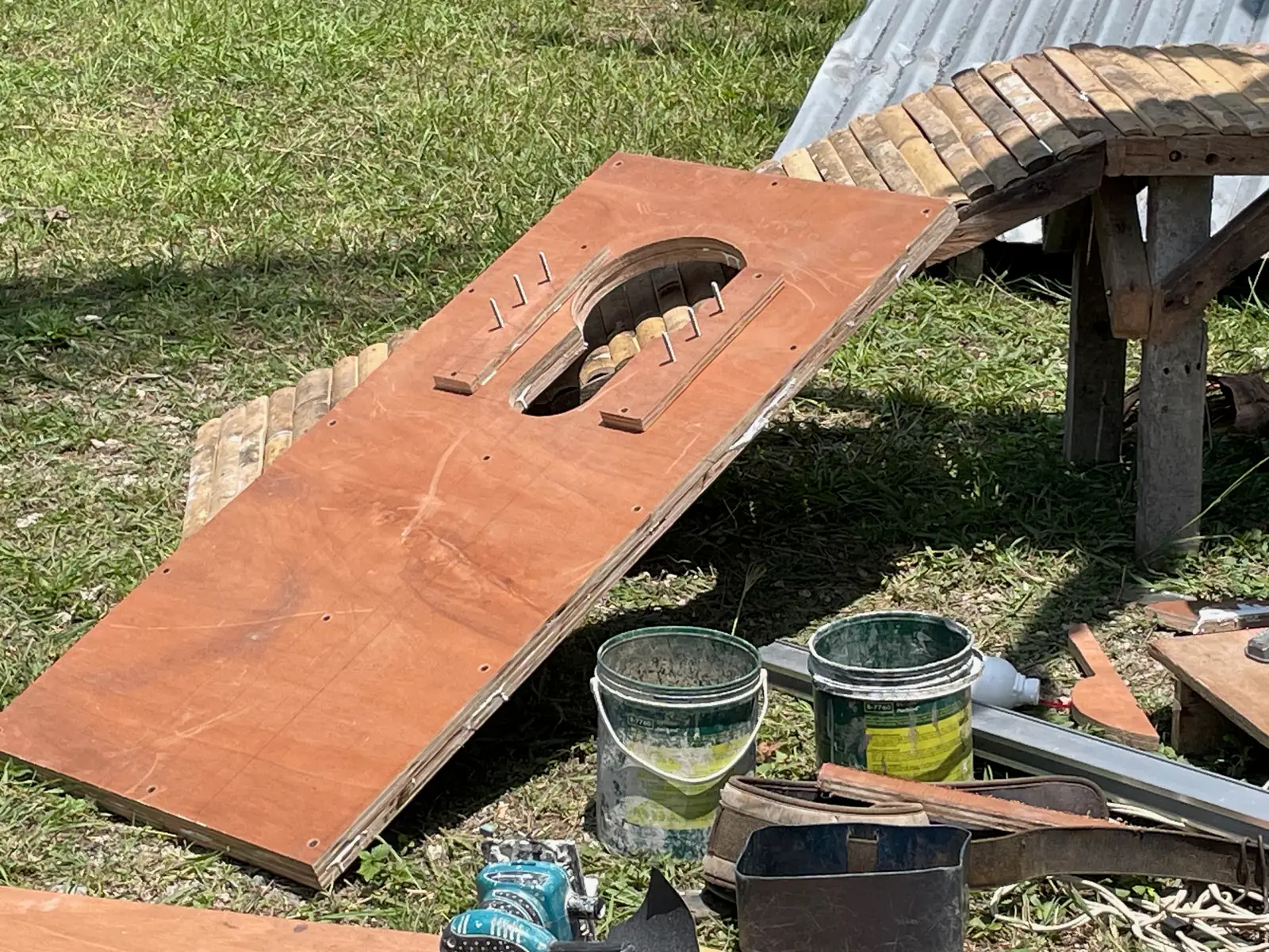 Laminated marine-plywood headboard with a keyhole opening and adjustable bolts for different goats.