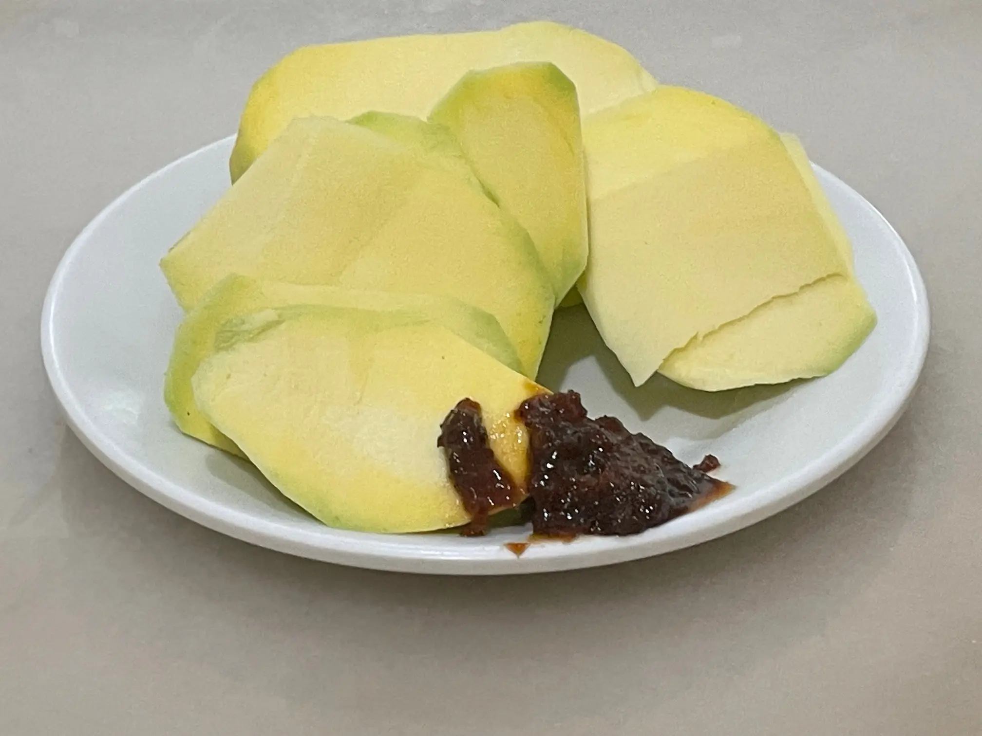 Sliced green mango served with bagoong in the Philippines
